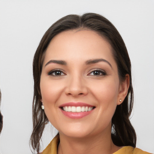 Joyful white young-adult female with medium  brown hair and brown eyes