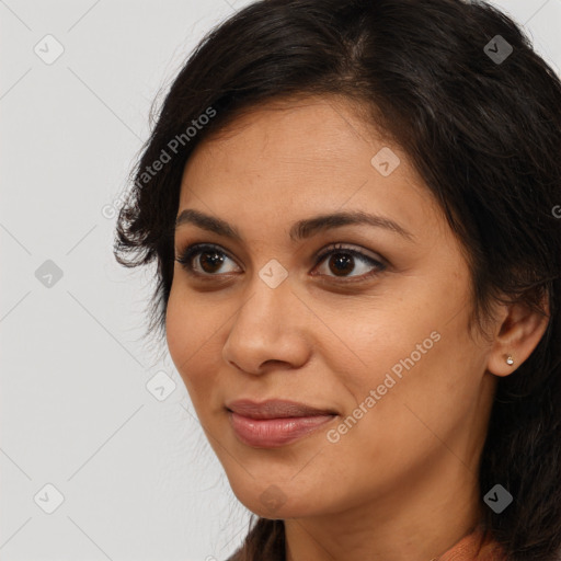 Joyful latino young-adult female with long  brown hair and brown eyes