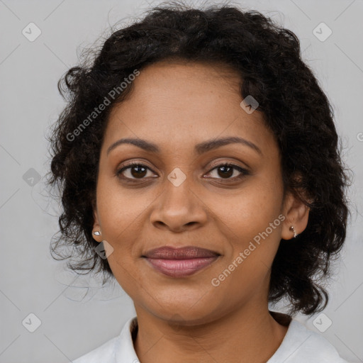 Joyful black adult female with medium  brown hair and brown eyes