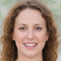 Joyful white young-adult female with medium  brown hair and green eyes