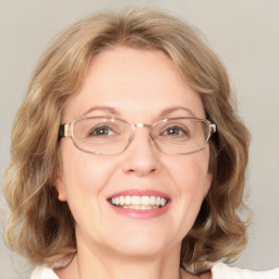 Joyful white adult female with medium  brown hair and blue eyes