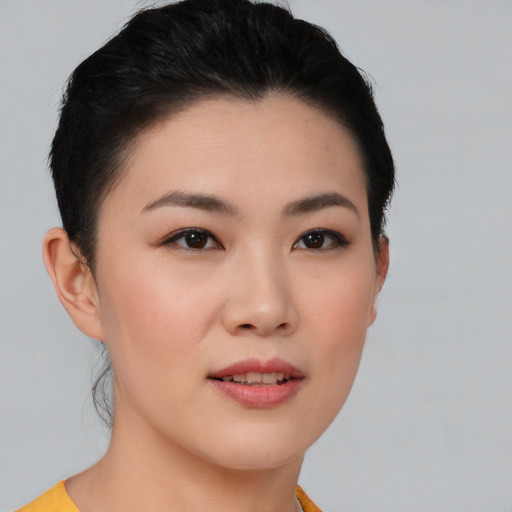 Joyful asian young-adult female with short  black hair and brown eyes