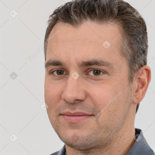 Joyful white adult male with short  brown hair and brown eyes