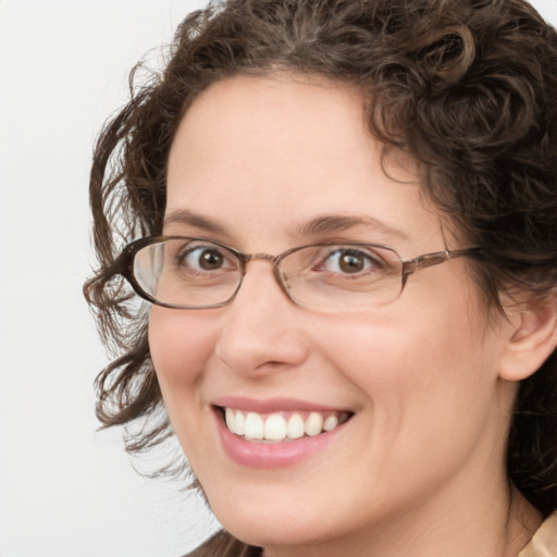 Joyful white adult female with medium  brown hair and green eyes