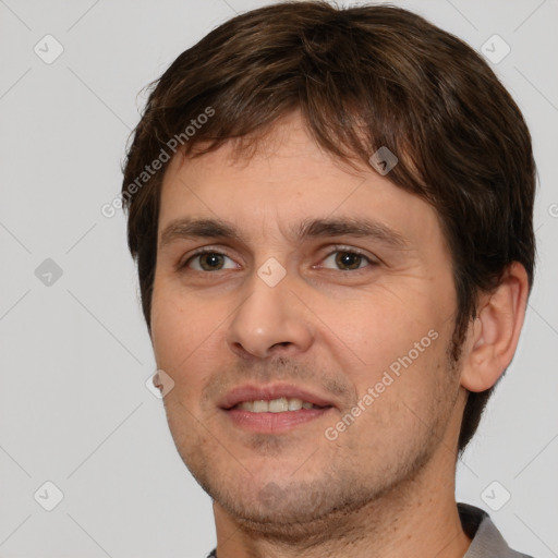 Joyful white young-adult male with short  brown hair and brown eyes