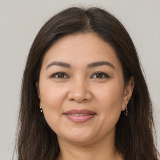 Joyful white adult female with long  brown hair and brown eyes