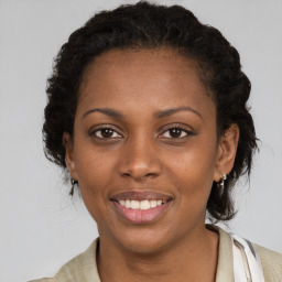 Joyful black young-adult female with medium  brown hair and brown eyes