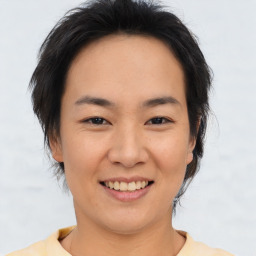 Joyful asian young-adult female with short  brown hair and brown eyes