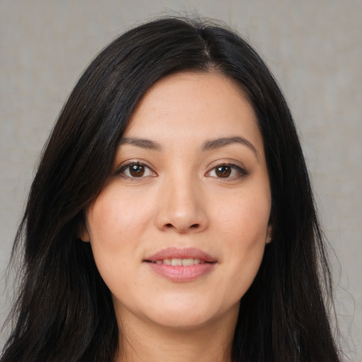 Joyful asian young-adult female with long  brown hair and brown eyes