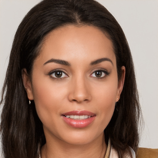 Joyful white young-adult female with long  brown hair and brown eyes