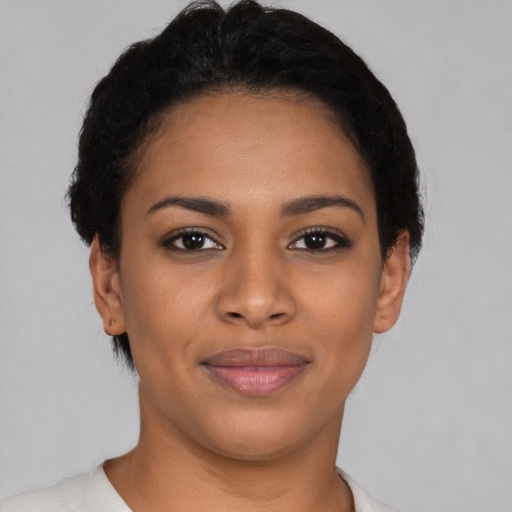 Joyful latino young-adult female with short  black hair and brown eyes