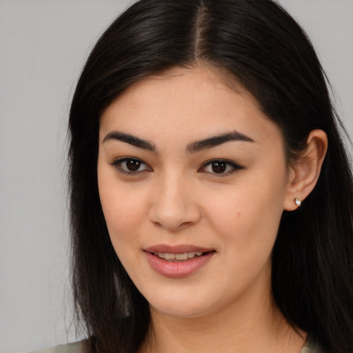 Joyful asian young-adult female with long  brown hair and brown eyes