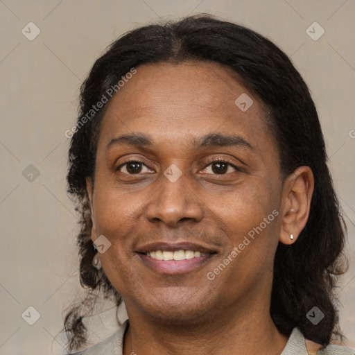 Joyful latino adult female with medium  brown hair and brown eyes