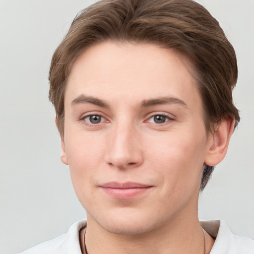 Joyful white young-adult female with short  brown hair and grey eyes