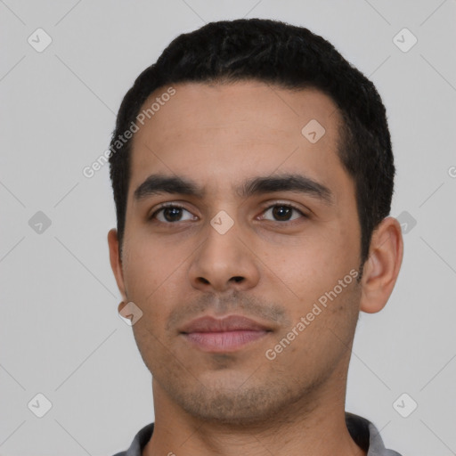 Neutral latino young-adult male with short  black hair and brown eyes