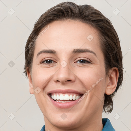 Joyful white young-adult female with medium  brown hair and grey eyes