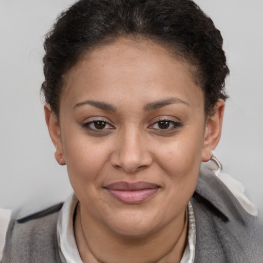 Joyful latino young-adult female with short  brown hair and brown eyes