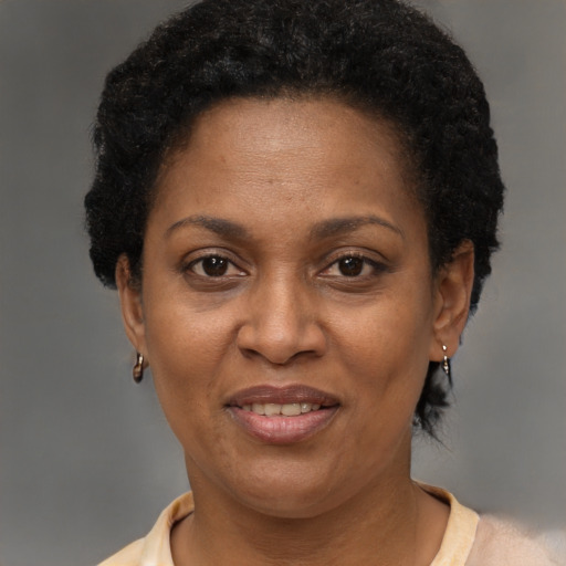 Joyful black adult female with short  brown hair and brown eyes