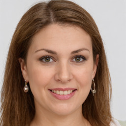 Joyful white young-adult female with long  brown hair and green eyes