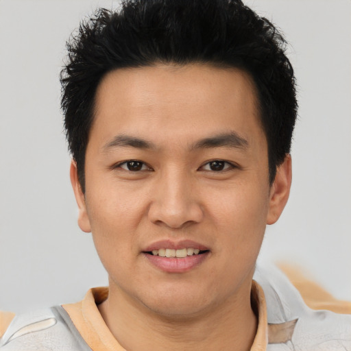 Joyful asian young-adult male with short  black hair and brown eyes