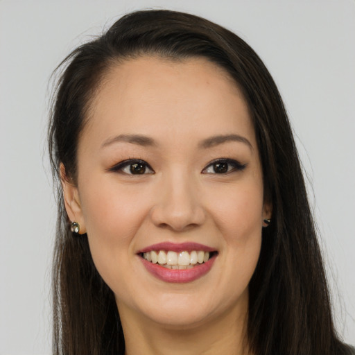 Joyful white young-adult female with long  brown hair and brown eyes