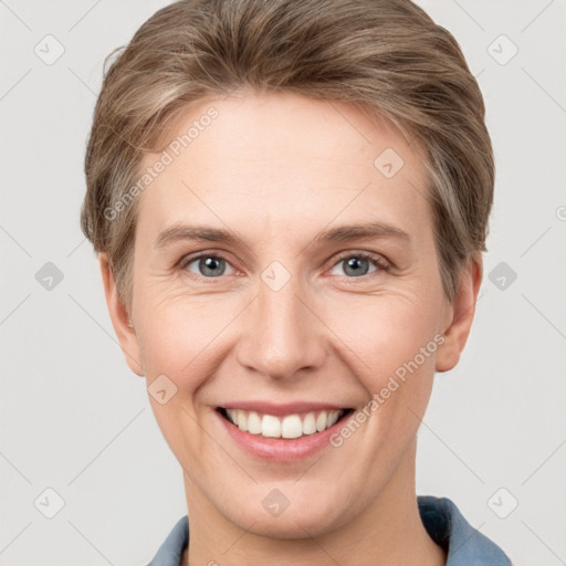 Joyful white young-adult female with short  brown hair and grey eyes