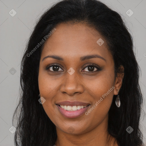 Joyful black young-adult female with long  brown hair and brown eyes