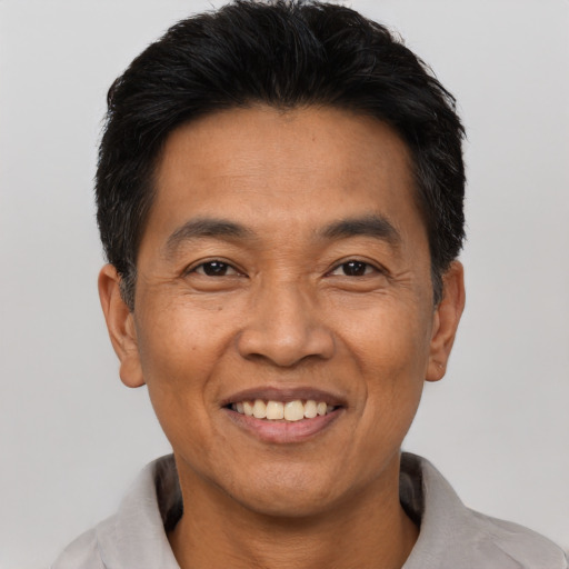 Joyful asian adult male with short  black hair and brown eyes