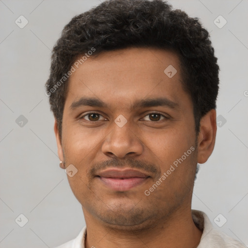 Joyful latino young-adult male with short  brown hair and brown eyes