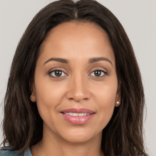 Joyful white young-adult female with long  brown hair and brown eyes