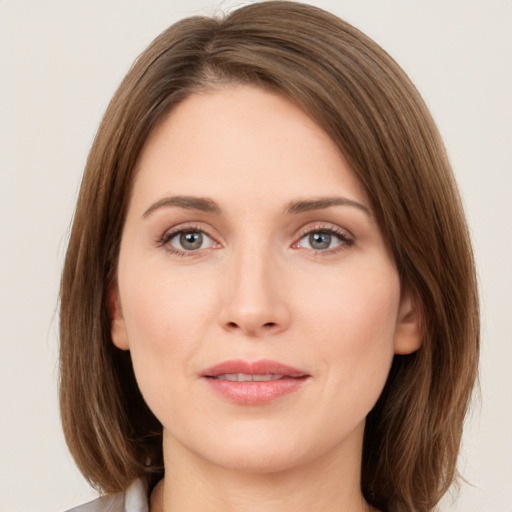 Joyful white young-adult female with medium  brown hair and green eyes