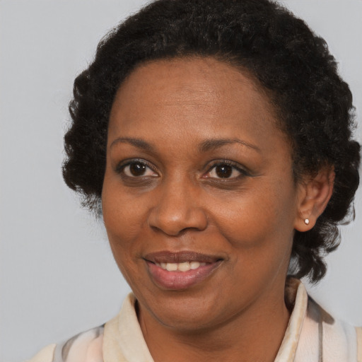 Joyful black adult female with short  brown hair and brown eyes