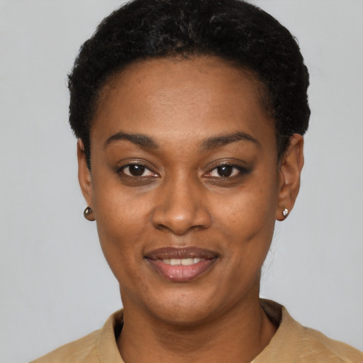 Joyful black young-adult female with short  black hair and brown eyes
