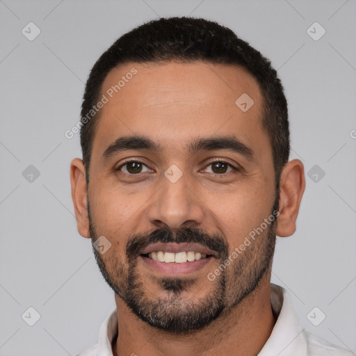 Joyful latino young-adult male with short  black hair and brown eyes