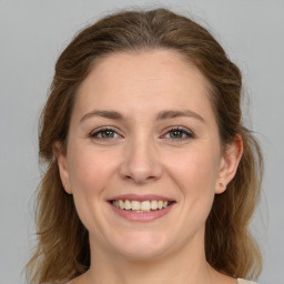 Joyful white young-adult female with medium  brown hair and grey eyes