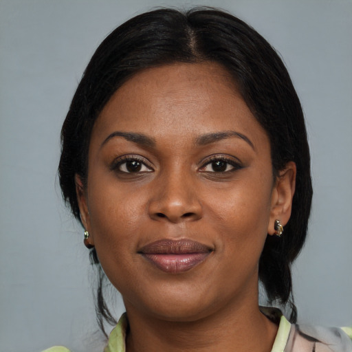 Joyful black adult female with medium  brown hair and brown eyes