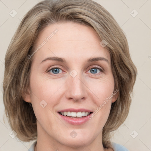 Joyful white adult female with medium  brown hair and blue eyes