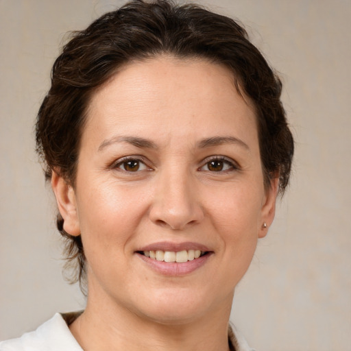 Joyful white adult female with medium  brown hair and brown eyes