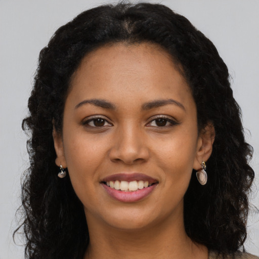 Joyful latino young-adult female with long  black hair and brown eyes