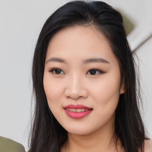 Joyful asian young-adult female with long  black hair and brown eyes