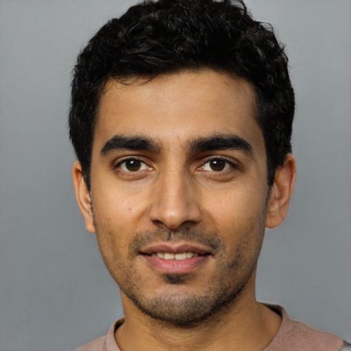 Joyful latino young-adult male with short  black hair and brown eyes