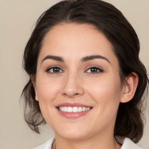 Joyful white young-adult female with medium  brown hair and brown eyes