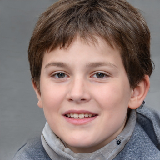 Joyful white child male with short  brown hair and grey eyes