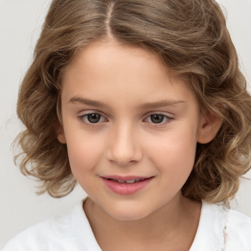 Joyful white child female with medium  brown hair and brown eyes