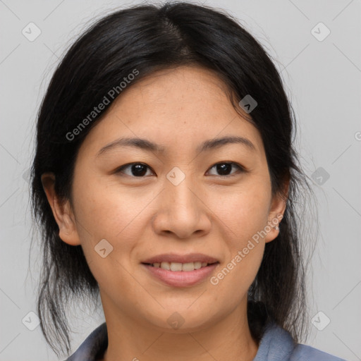 Joyful asian adult female with medium  brown hair and brown eyes