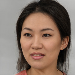 Joyful asian young-adult female with medium  brown hair and brown eyes