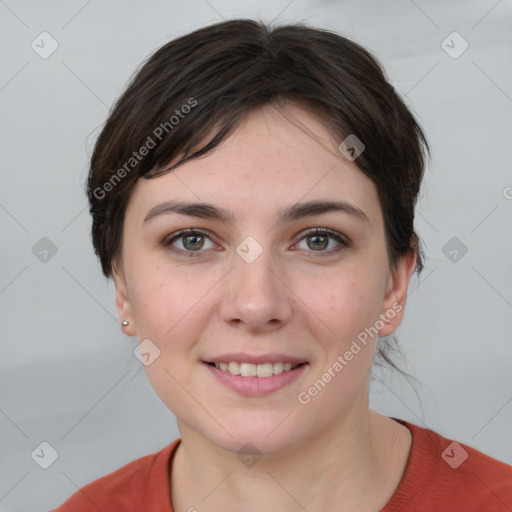 Joyful white young-adult female with short  brown hair and grey eyes