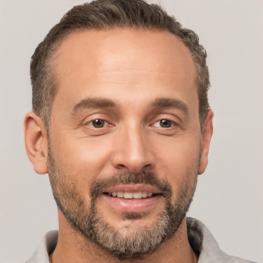 Joyful white adult male with short  brown hair and brown eyes