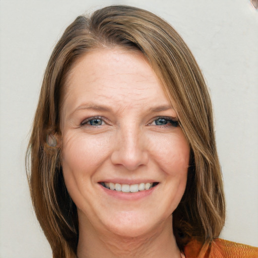 Joyful white adult female with medium  brown hair and grey eyes