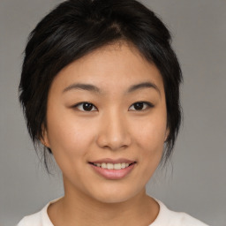 Joyful asian young-adult female with medium  brown hair and brown eyes